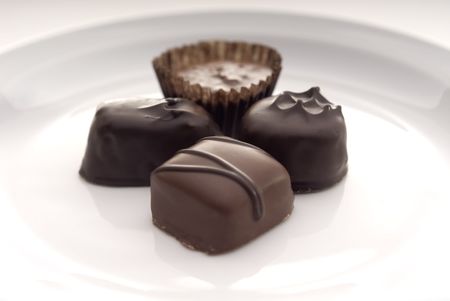 A closeup of some chocolates on a white plate.Suitable for Valentines Day topics, birthday topics,...