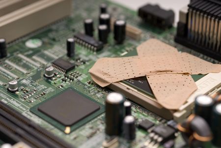 Bandages on a computer processor - concept of a computer virus or a computer in need of repairの写真素材