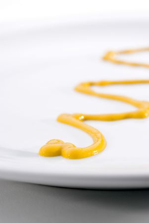 A close-up of yellow mustard on a plateの写真素材