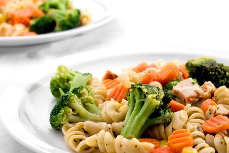 Two dishes of pasta with mixed vegatablesの写真素材