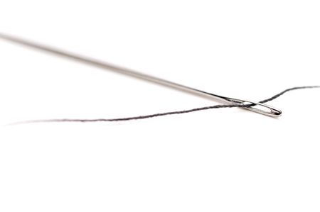 Macro of a needle and dark threadの写真素材