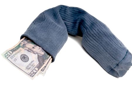 Us currency stuffed into a sock for savings instead of using the bankの写真素材