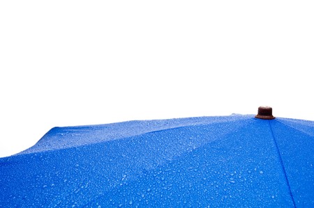 Horizontal view of a blue umbrella with rain drops on whiteの写真素材