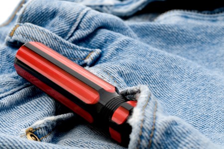 Red and black screwdriver in jeans pocketの写真素材