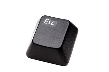 A horizontal closeup of an Escape button from a computer keyboard on whiteの写真素材