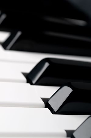 A shallow focus close up of piano keyboard  keys