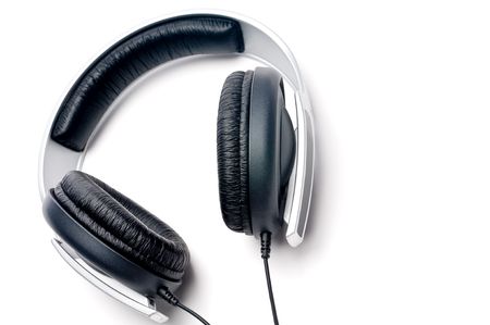 Tilted horizontal image of silver colored headphones with black leather paddingの写真素材