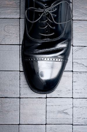 Black leather business shoe on a dark backgroundの写真素材