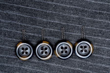 Close up of four buttons on a pin-striped suit jacketの写真素材