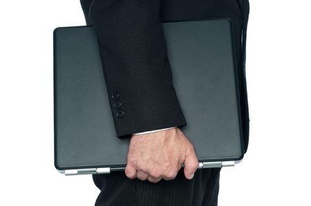 Horizontal image of a man in a business suit carrying a notebook computerの写真素材