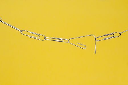 horizontal breaking paperclip chain on yellow