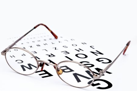 Horizontal image of eyeglasses on a eye exam chartの写真素材