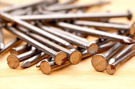 Horizontal close-up of construction nails on woodの写真素材