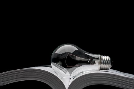 a lightbulb on a book showing ideas from inspiration and education