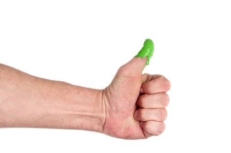 A man with a green thumb on whiteの写真素材