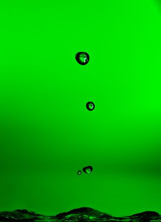 Abstract of bubbles in water lit in greenの写真素材