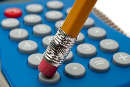 Shallow focus macro of a pencil eraser pushing a calculator buttonの写真素材