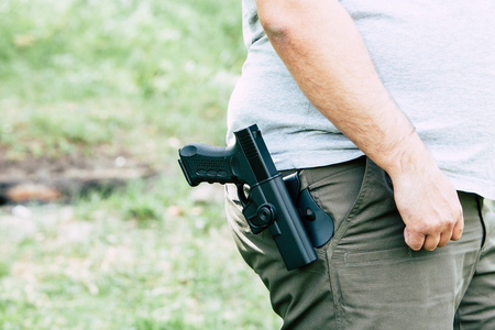 Pistol in the holster. The shooter trains. Is preparing to shoot at the targetの写真素材