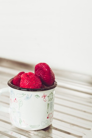 Fresh strawberries in a cup.の写真素材