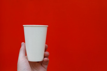 White paper glass on a red backgroundの写真素材