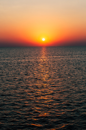Dawn or sunset on the sea, the ocean, the lake. Beautiful view. The sun is visible.の写真素材