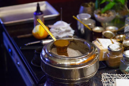 Making Turkish Coffee in the Sand. Oriental eastern tradition of Turkey, selective focus copy space.の写真素材