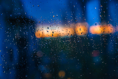 Drops on the window. Thunderstorm and rain behind the glassの写真素材