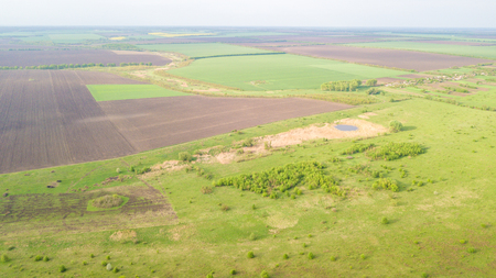 River and fields top view. Photographed from the drone. Beautiful view of the agropolis. Spring. Green fieldsの写真素材
