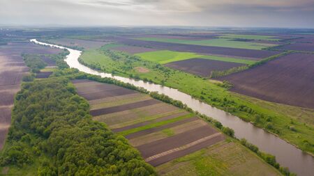River and fields top view. Photographed from the drone. Beautiful view of the agropolis. Spring....