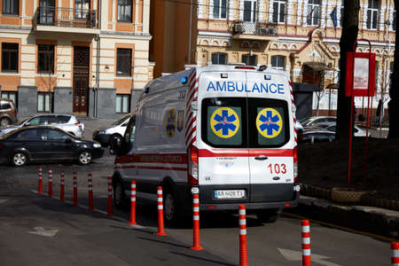 02/28/2020 Ukraine. Kyiv. Teachings. Doctors transport the patient for coronavirus to an infectious diseases hospital. Doctors in protective suits. Patient in a protective maskのeditorial素材