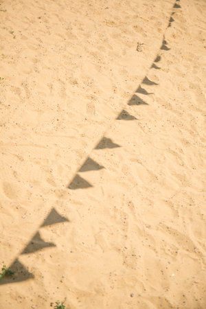 Funny shadows of flags on the sand. Concert-festival, partyの写真素材