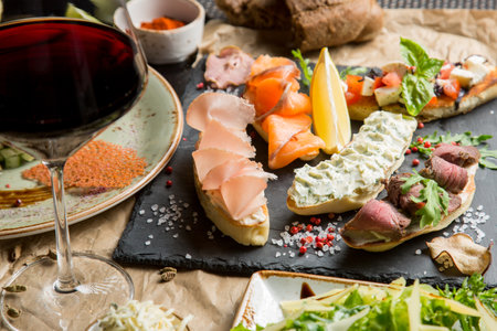 Sandwiches with salted salmon and cottage cheese. Bruschetta with various toppingsの写真素材