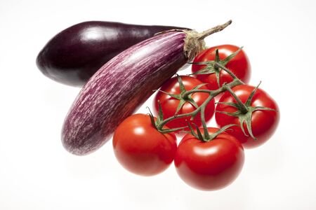Fresh eggplants and tomatos over white backgroundの写真素材