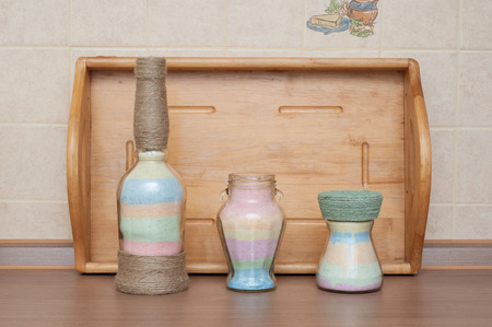 Decorated bottles wrapped with colored thread inside saltの写真素材