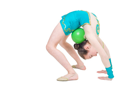 Little girl gymnast with green ball. Isolated on white background. Sporting exercise, stretch, flexibility, aerobicsの写真素材