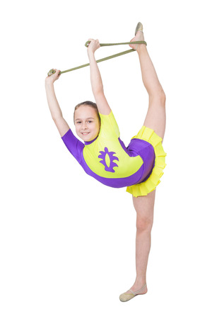 Cute young girl doing gymnastics isolated over whiteの写真素材
