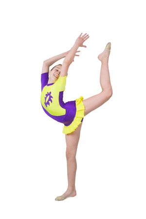 Cute young girl doing gymnastics isolated over whitecの写真素材