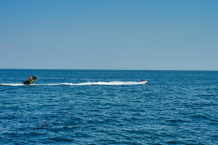 Odessa, Ukraine - AUGUST 31, 2015: The hydrocycle tows the inflatable watercraft banana. A sea attraction "driving on banana"のeditorial素材