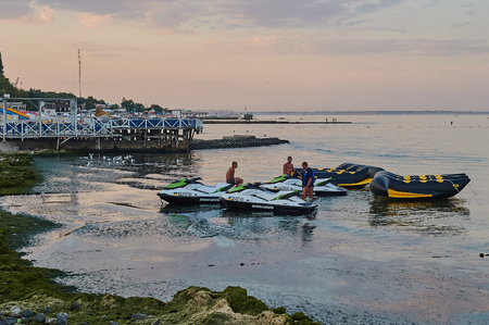 Odessa, Ukraine - AUGUST 31, 2015: The hydrocycle tows the inflatable watercrafts banana on the beach. A sea attraction "driving on banana".のeditorial素材