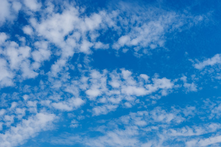 Blue sky background with tiny cloudsの写真素材