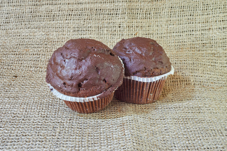 Chocolate muffin on a burlap in a rustic style.の写真素材