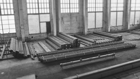 Warehouse with metallurgical material. Steel metal pipes in the package. Black and white image with tilt-shift effect.の写真素材