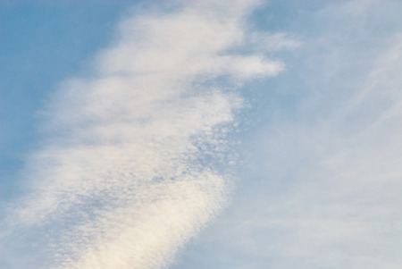 Blue sky background with tiny clouds