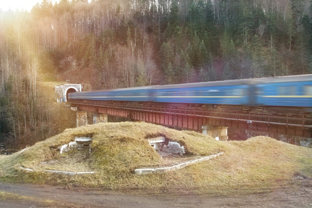 Old diesel passenger train in tunnel. Train in motion. Mountain railroad in Yaremche, Ukraineの写真素材