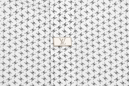 KRIVOY ROG, UKRAINE - NOVEMBER 26, 2015: Button on shirt with LOUIS VUITTON logo.