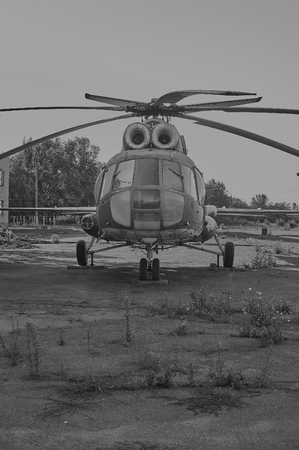 KRIVOY ROG, UKRAINE - FEBRUARY 6, 2016: Old soviet helicopter MI-8 at an abandoned aerodrome. Black and white imageのeditorial素材