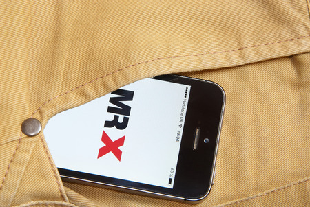 KRIVOY ROG, UKRAINE - JANUARY : iPhone 5s with mobile application for MR X on the screen in orange jeans pocketのeditorial素材