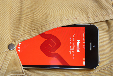 KRIVOY ROG, UKRAINE - JANUARY : iPhone 5s with mobile application for Hookd on the screen in orange...