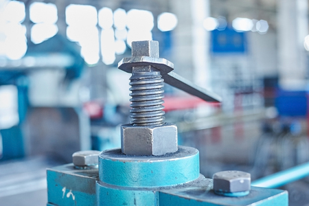 Big industrial wrench tool and nut. Close up image, toned in cold toneの写真素材