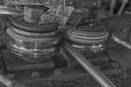 Rolling forming rolls metal works on manufacture of pipes. Rolling mill machine for rolling steel sheet. Black and white imageの写真素材